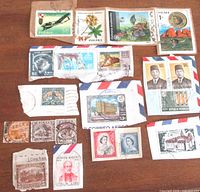 Overview of assorted stamps spread on wooden surface