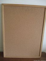 Front view of cork board in wood frame