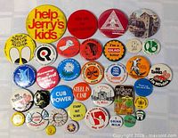 Entire assortment of vintage pinback buttons laid out for view