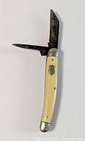 Knife open showing both blades, handle, shield inlay