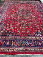 Full view of rug showing central medallion and entire border