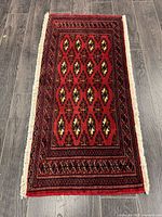Full view of handmade Turkman rug showing pattern and fringe