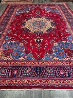 Full view of handmade Persian rug showing central medallion and borders