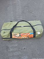 Full view of green carry bag holding folding cot