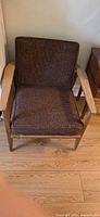 Front view showing wood frame, seat and back cushions