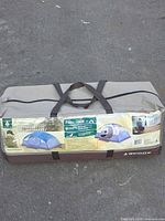 Full view of tent carry bag showing size and brand