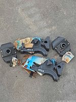 Two Scotty rod holders with packaging and two mounting bases on ground