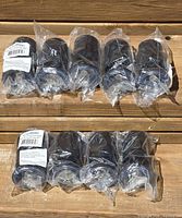 All nine packaged metal legs arranged on wood surface