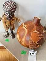 Overall view of gourd vase and tribal doll