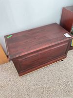 Top and side view of closed mahogany veneer blanket chest