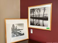 Front view of both framed prints leaning against wall