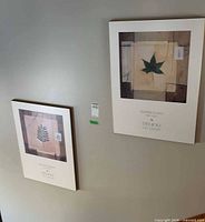 Both posters hanging on wall, showing relative size and mounting