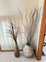 Both floor vases with decorative stems
