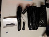 Hair trimmer with accessories laid out: manual, device, USB cable, trim guide, pouch