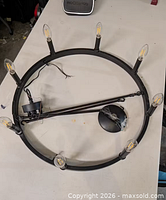 Top view of black ring chandelier with eight LED bulbs, canopy and downrod attached