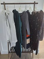 Full rack showing six dresses on hangers