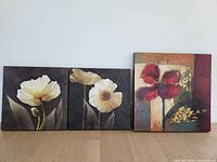 Front view of three canvases showing artwork