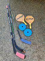 Overall lot: three hockey sticks, two Smashball paddles, two blue weight plates