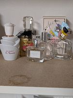 Group of five empty perfume bottles on shelf