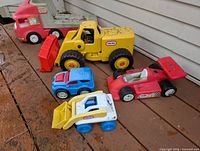 All six Little Tikes toy vehicles on deck
