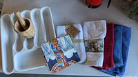 All items laid out: cutlery tray, mortar & pestle, napkin pack, towel bundle, three loose towels