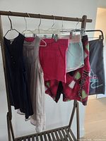 Overview of six garments hanging on rack