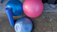 Overall view of two stability balls, balance trainer, and yoga mat