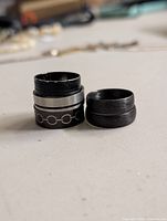 Stack of three rings showing different finishes and inlay