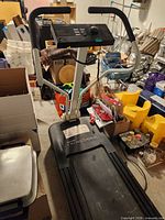 Full view of treadmill showing deck, uprights, console and surrounding area