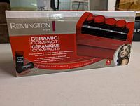 Front of sealed box showing Remington Style Ceramic Compact Hot Rollers