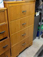Front view of tallboy showing four drawers and metal pulls