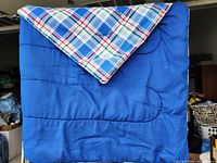 Full view showing solid blue side with plaid corner turned