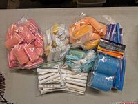 Main assortment of seven bags/packs of rollers on table