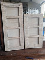 Front view of both wood picture frames showing three openings each