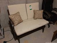 Front view of glider bench, cushions and pillows visible