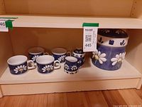 Full set on shelf: four mugs, creamer, sugar bowl with lid