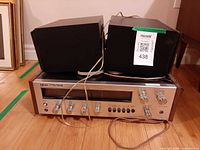 Akai AA-8030 receiver front view with two speakers positioned on top