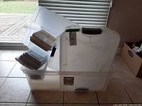 Overall view of stacked clear plastic totes and smaller containers