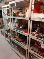 Full view of beige plastic five-shelf rack loaded with items (contents excluded)