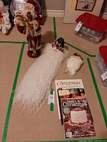 All items grouped: Santa figurine, wall hanging, ornament, book and magazines