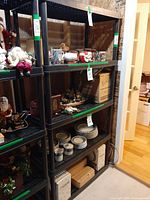 Full view of black five-shelf Rimax rack loaded with items (items on shelves not included)