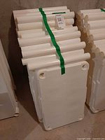 Stacked white plastic shelf panels and support posts