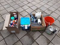Full lot showing three boxes, orange bucket, Path Clear jug
