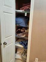 Full closet view showing multiple shelves filled with folded linens