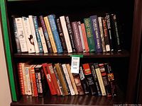 Two shelves of assorted books showing variety and quantity
