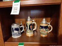 Front view showing all three beer steins on shelf
