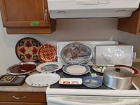 Overall view showing majority of trays, plates, cheese board and food dome