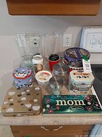 Group shot showing all tins, jars, vases and canisters on countertop