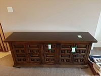 Front view of Drexel Et Cetera credenza showing five carved doors and hardware