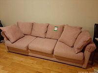 Front view of dusty rose sofa with cushions